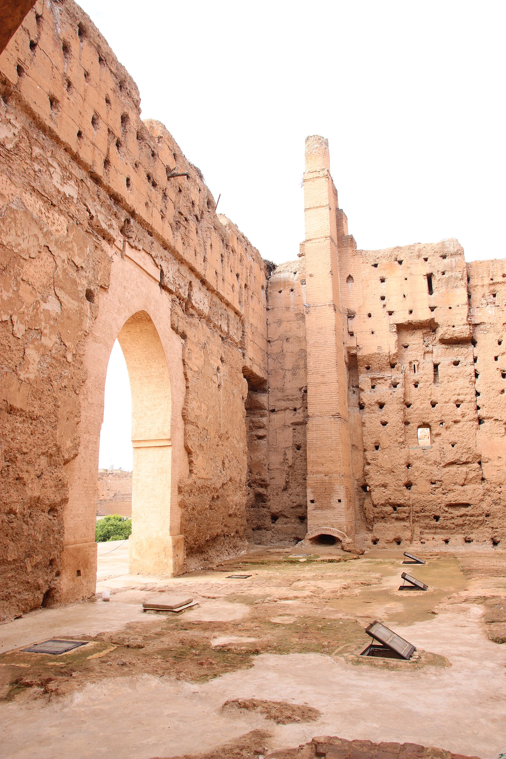 Sunlit arch and high ochre walls in the ruins of El Badi Palace, Marrakech